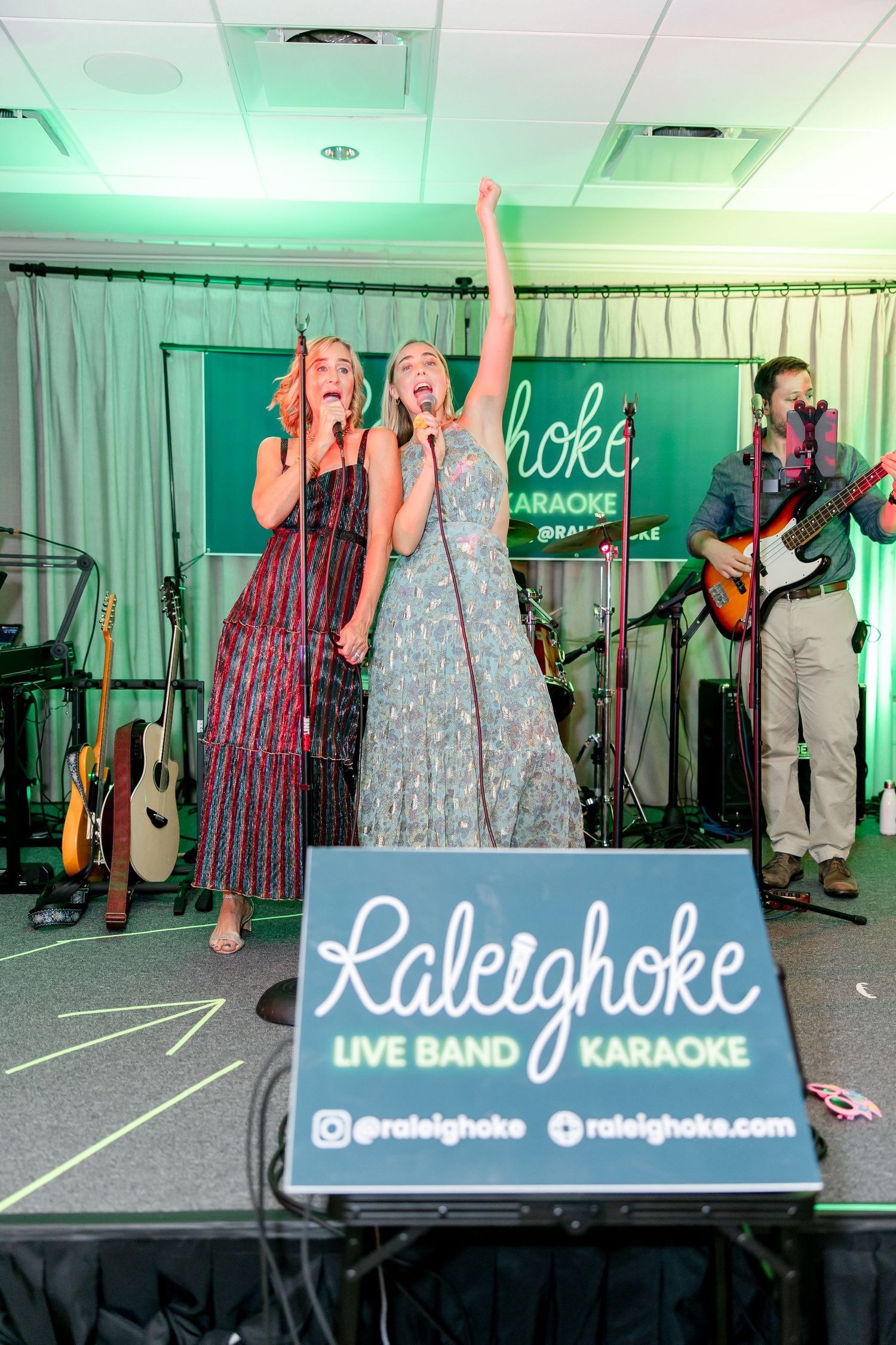 Live band karaoke performance at Raleighoke with musicians and singers on stage.