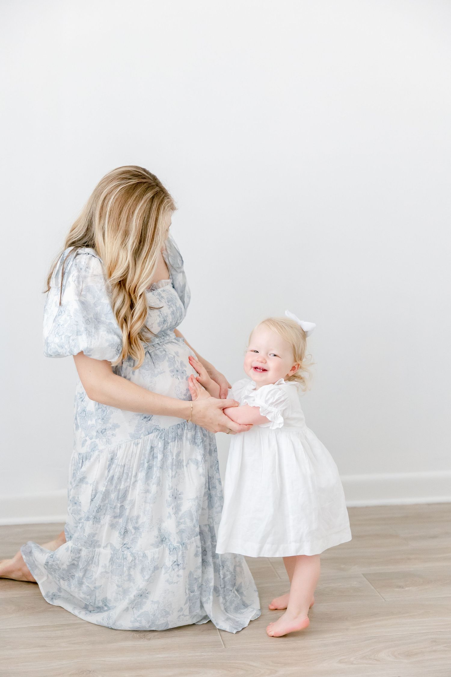 Sweet candid moments captured in a series showing playful interactions against a white backdrop.