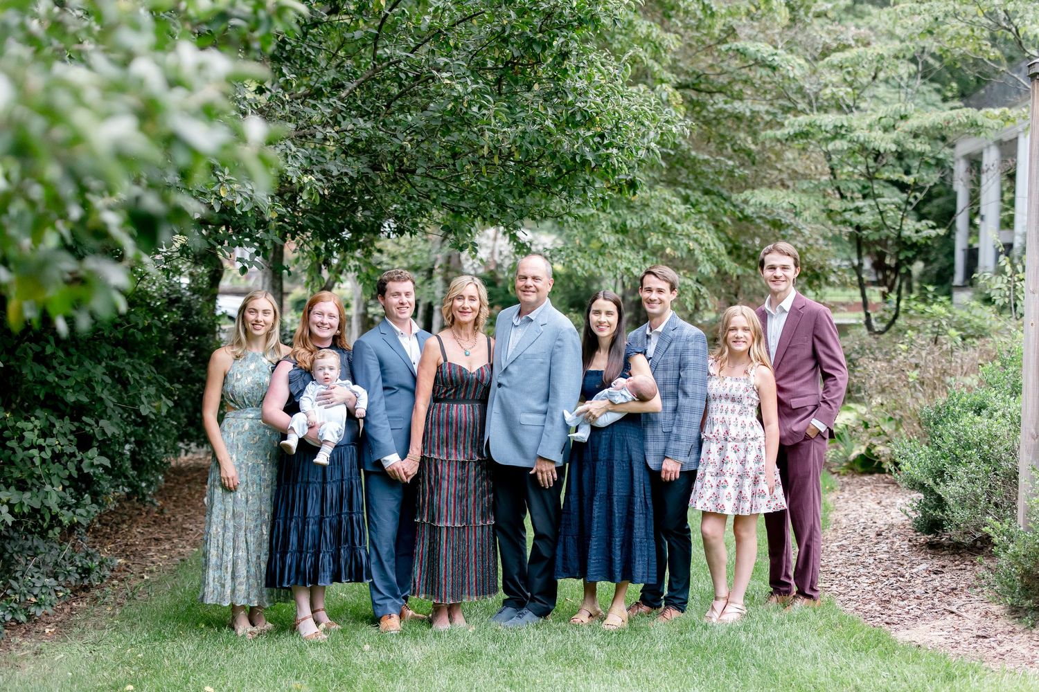 A collage of outdoor group portraits shows people gathered in natural settings with green foliage in the background.