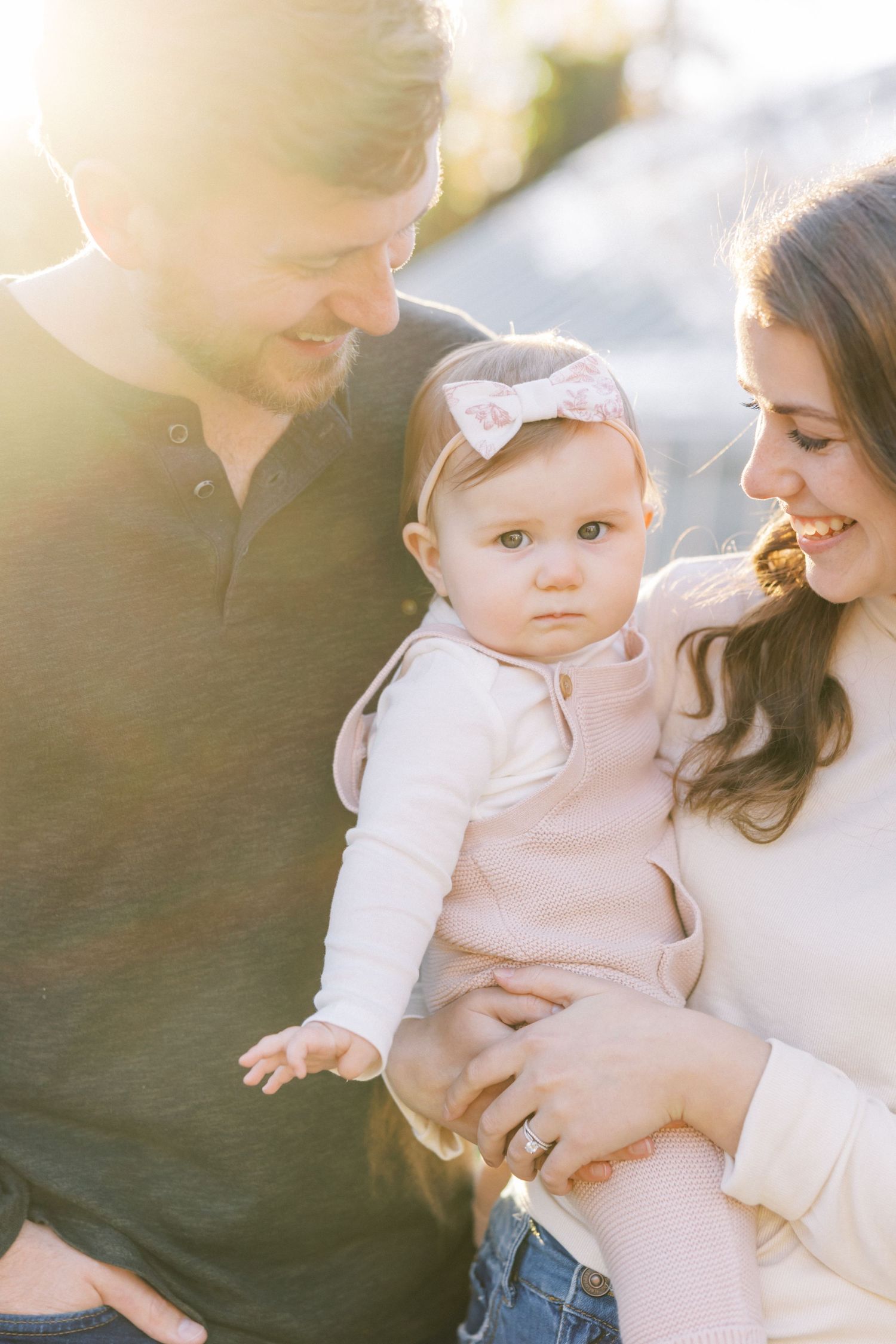 A series of soft, dreamy lifestyle portraits showing loving interactions between a baby and parents in natural light.