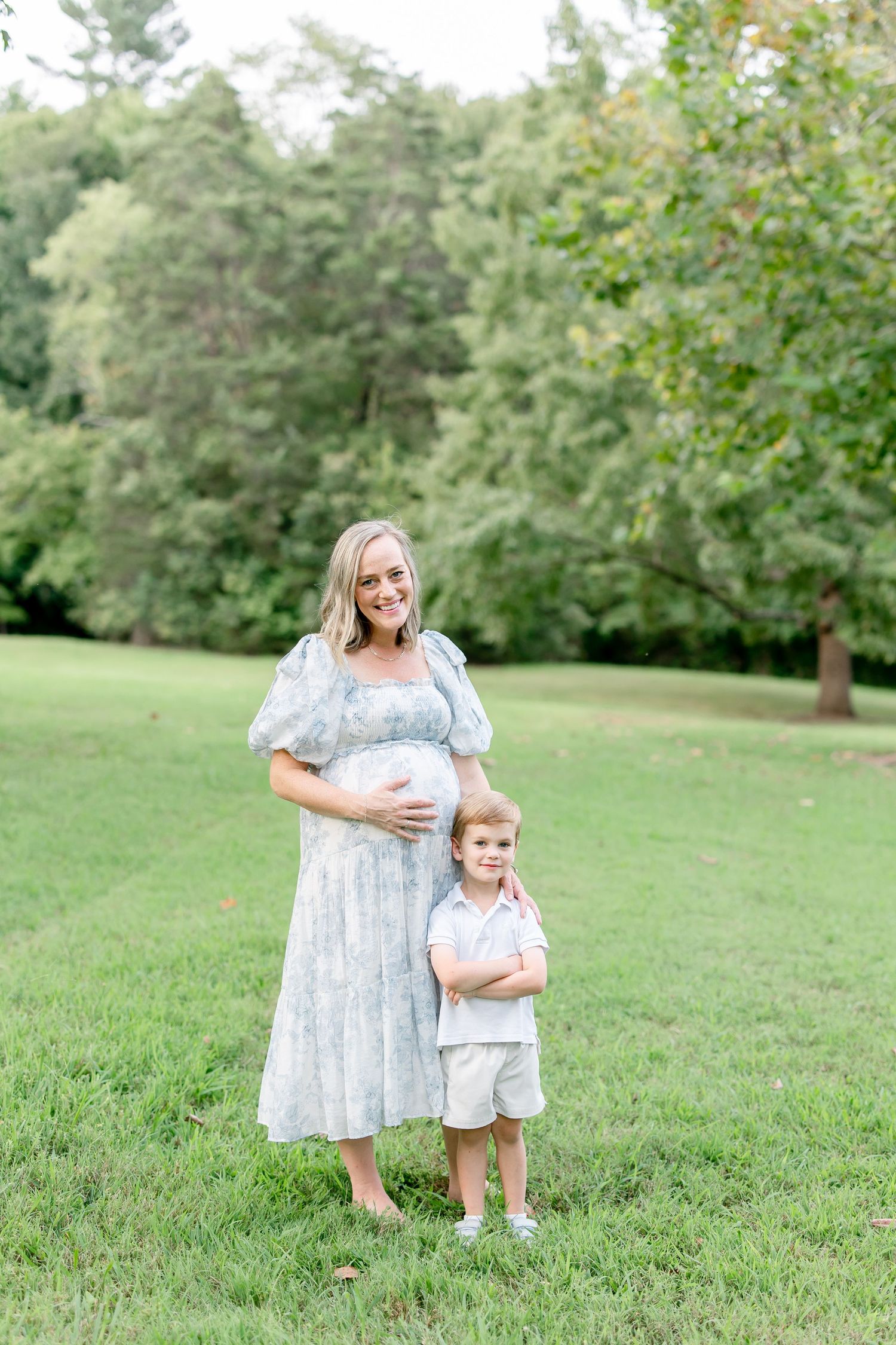 Mother and child sharing a quiet moment together in a peaceful park setting.