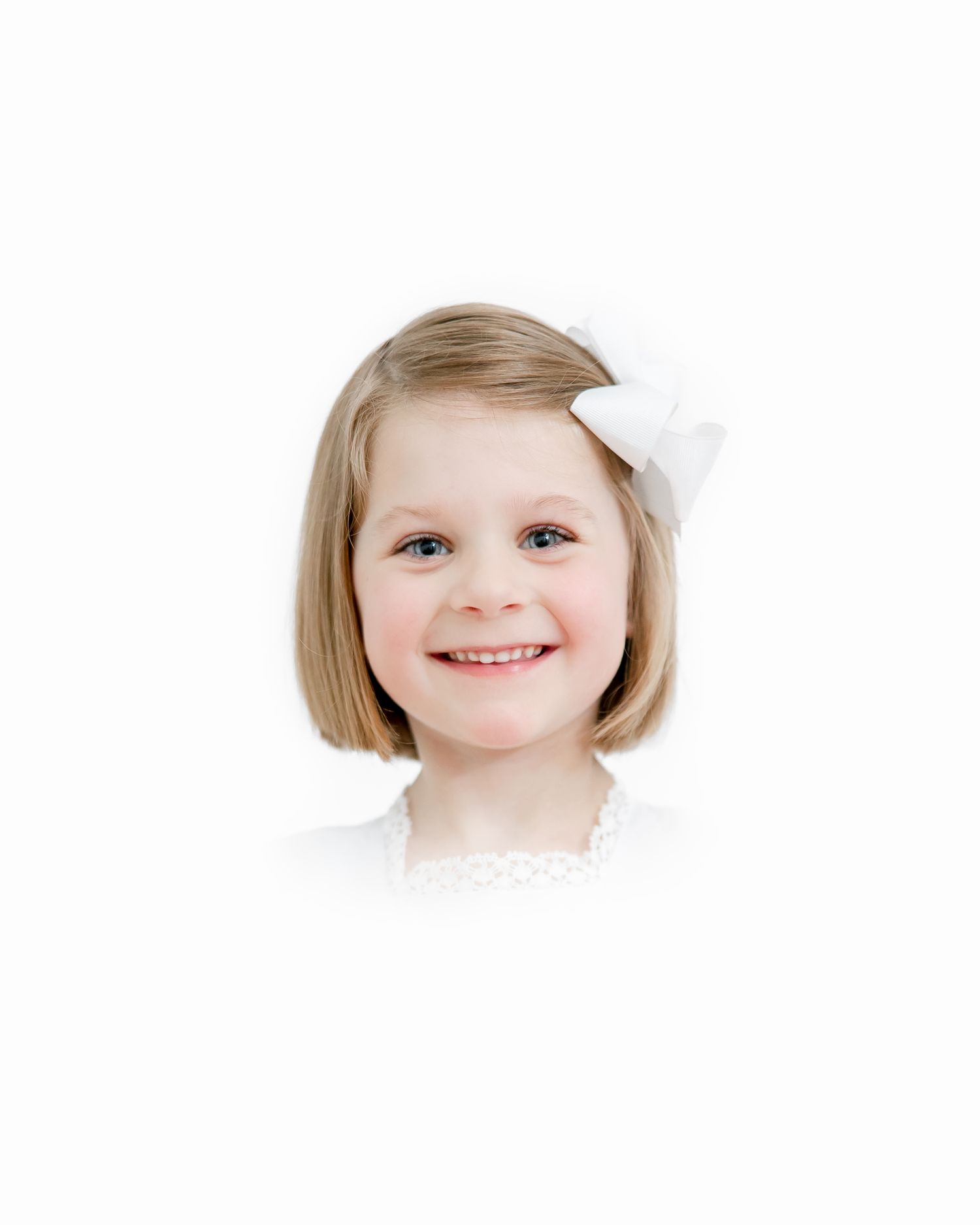 Portrait of young child wearing white bow accessory against white background.