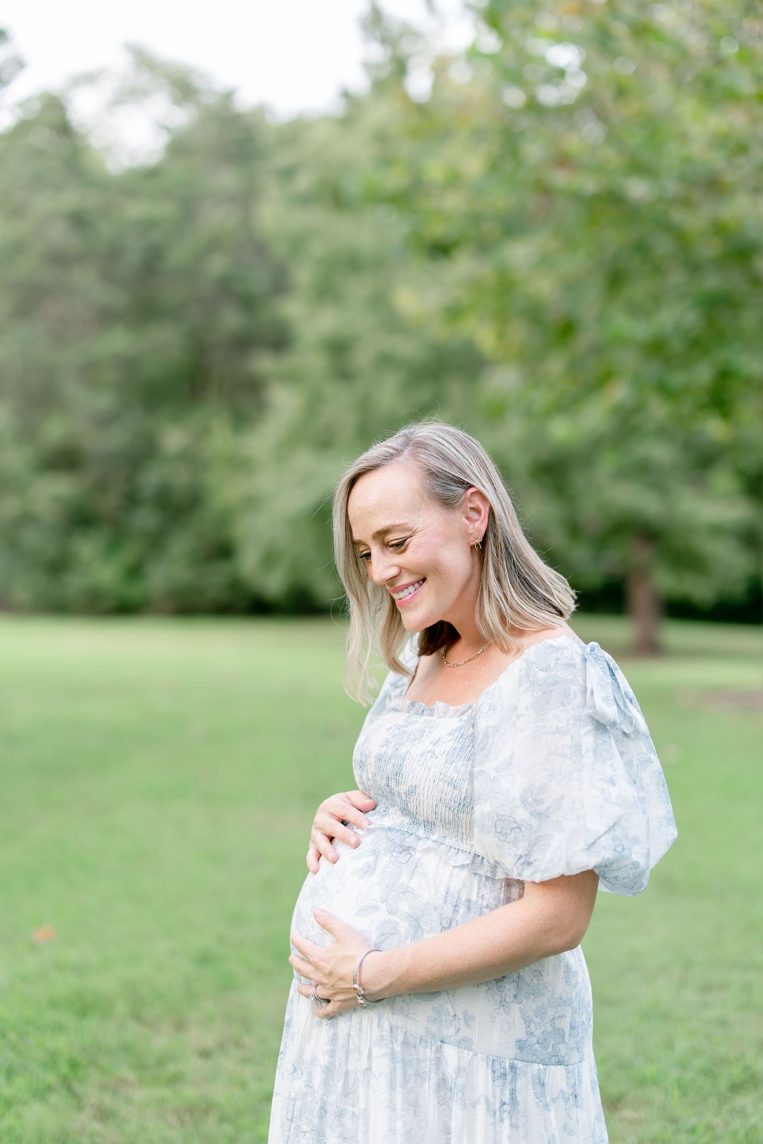 Beautiful maternity portraits featuring gentle poses in a serene outdoor setting.