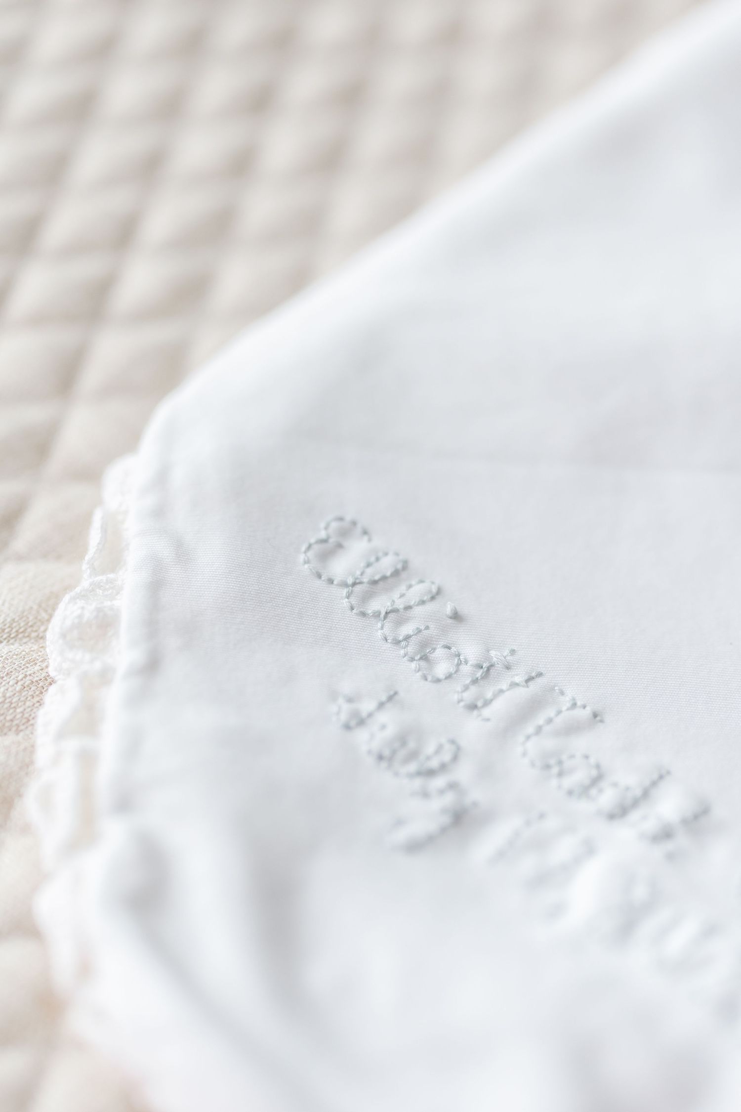 Close-up view of delicate embossed details on white paper creating an elegant textural pattern.