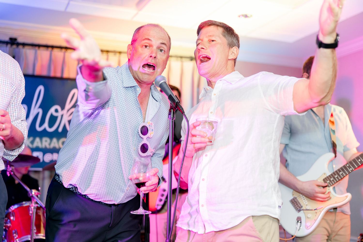 Party scenes with people dancing and celebrating under pink and purple mood lighting.