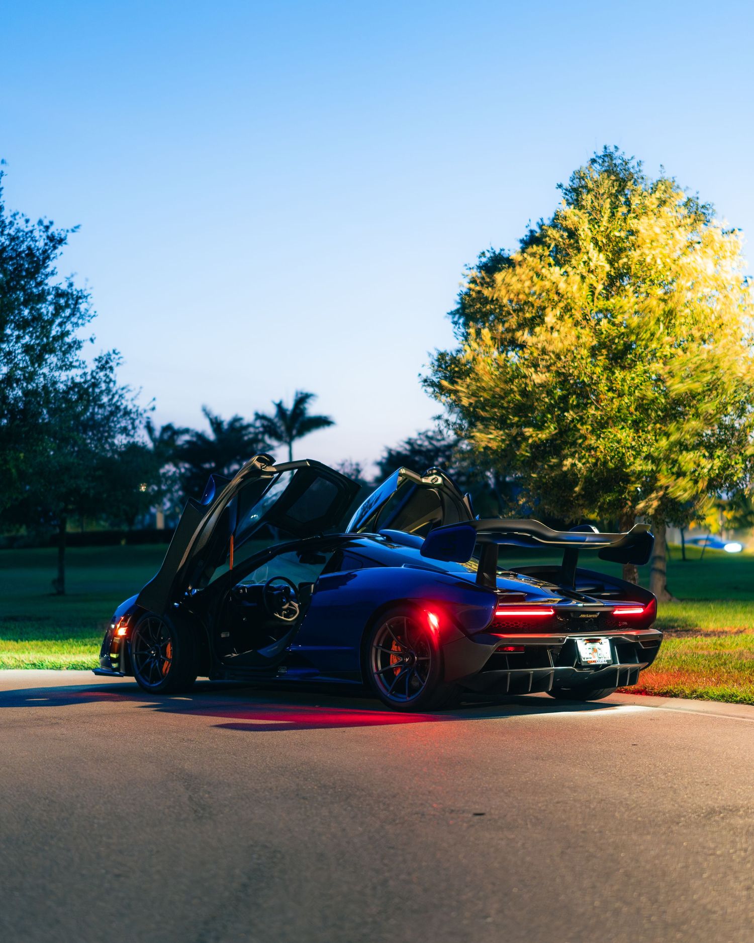 McLaren Senna with doors up at golden hour, photographed on a quiet Florida street