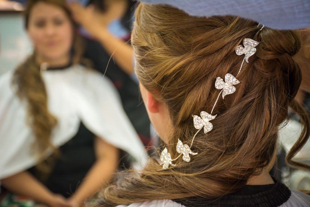 Close-up of elegant bridal hairstyle adorned with delicate white butterfly hair pins.