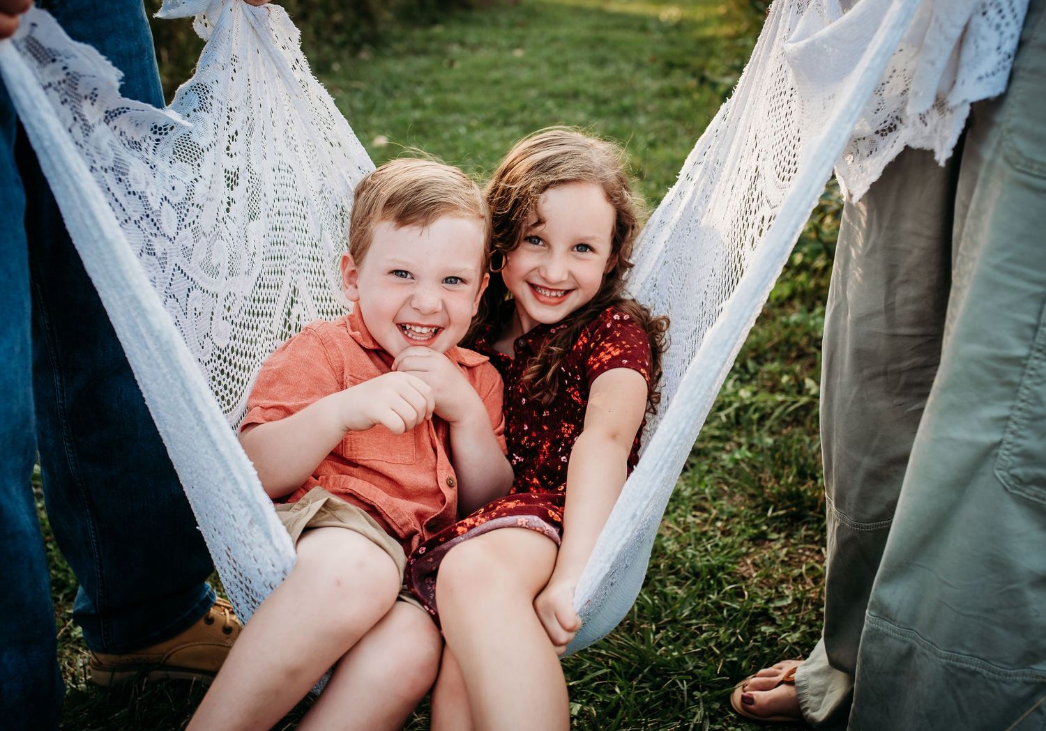 Family lounges together in a white hammock during an outdoor photo session.