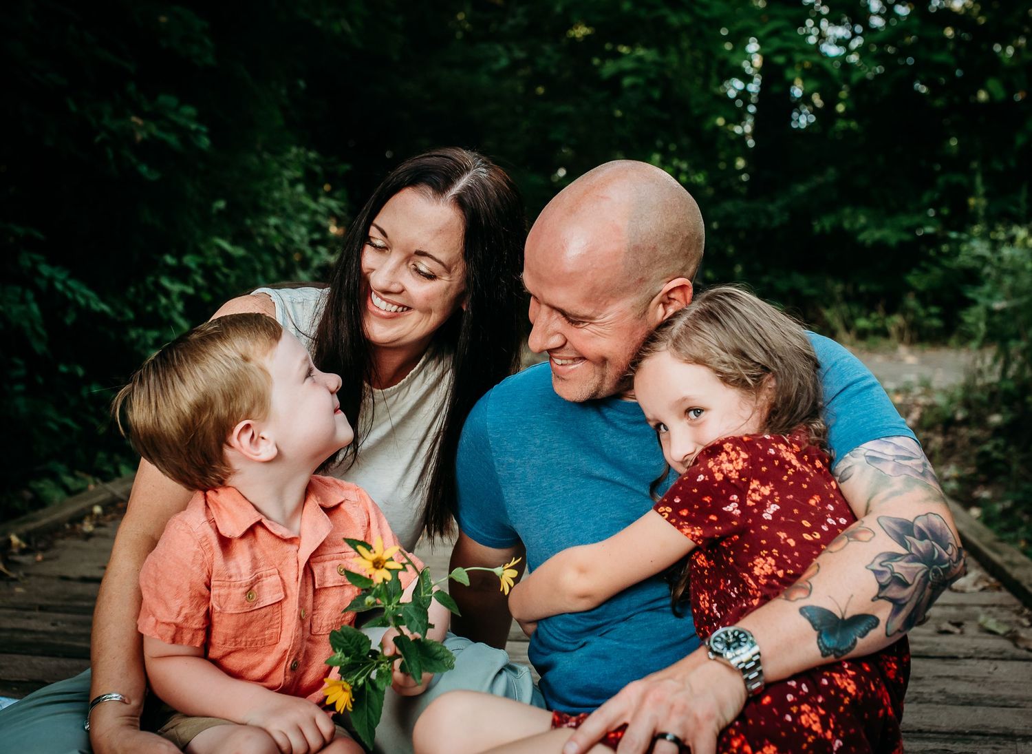 A family shares intimate moments together while relaxing outdoors.