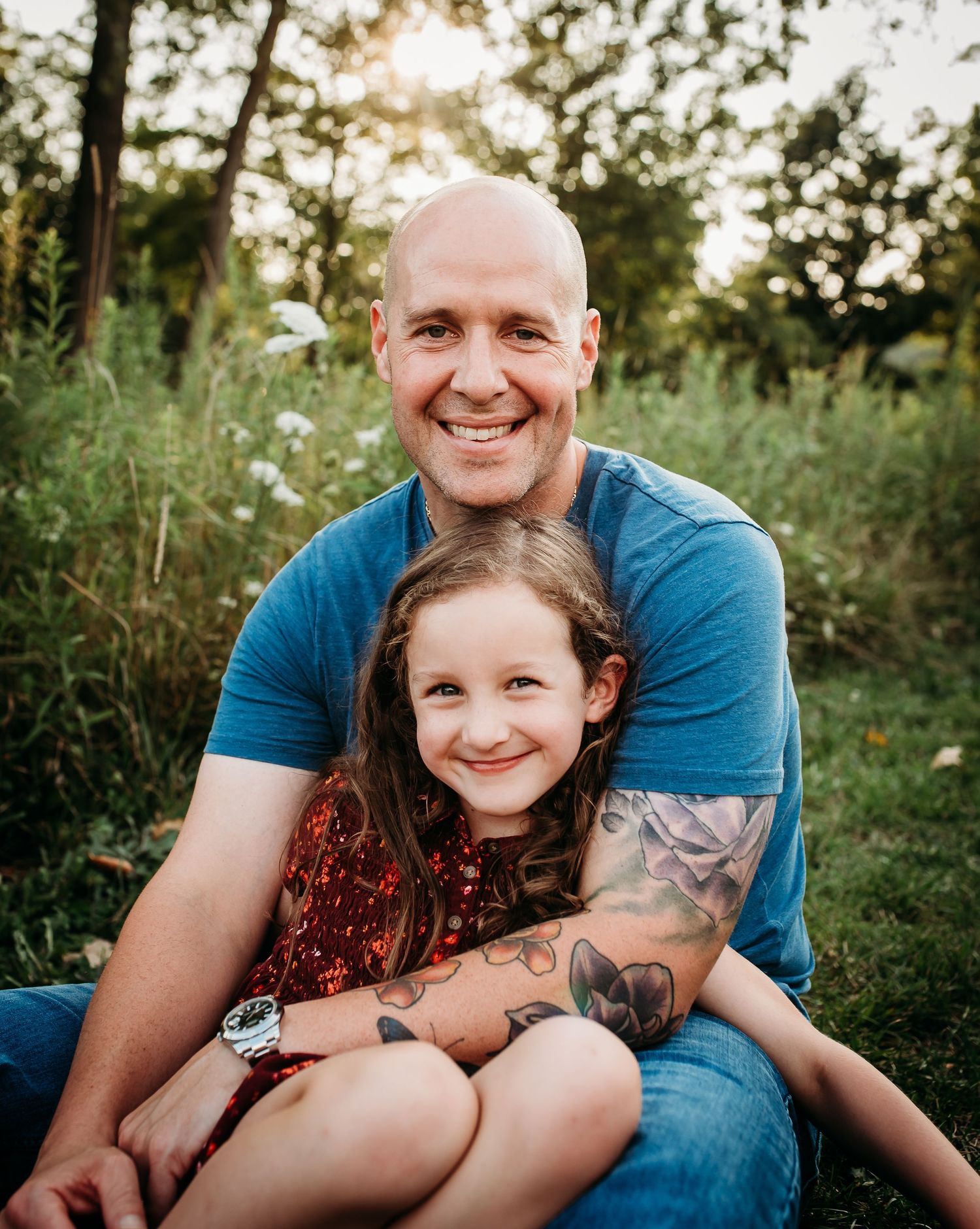 Candid family moment captured outdoors during golden hour.