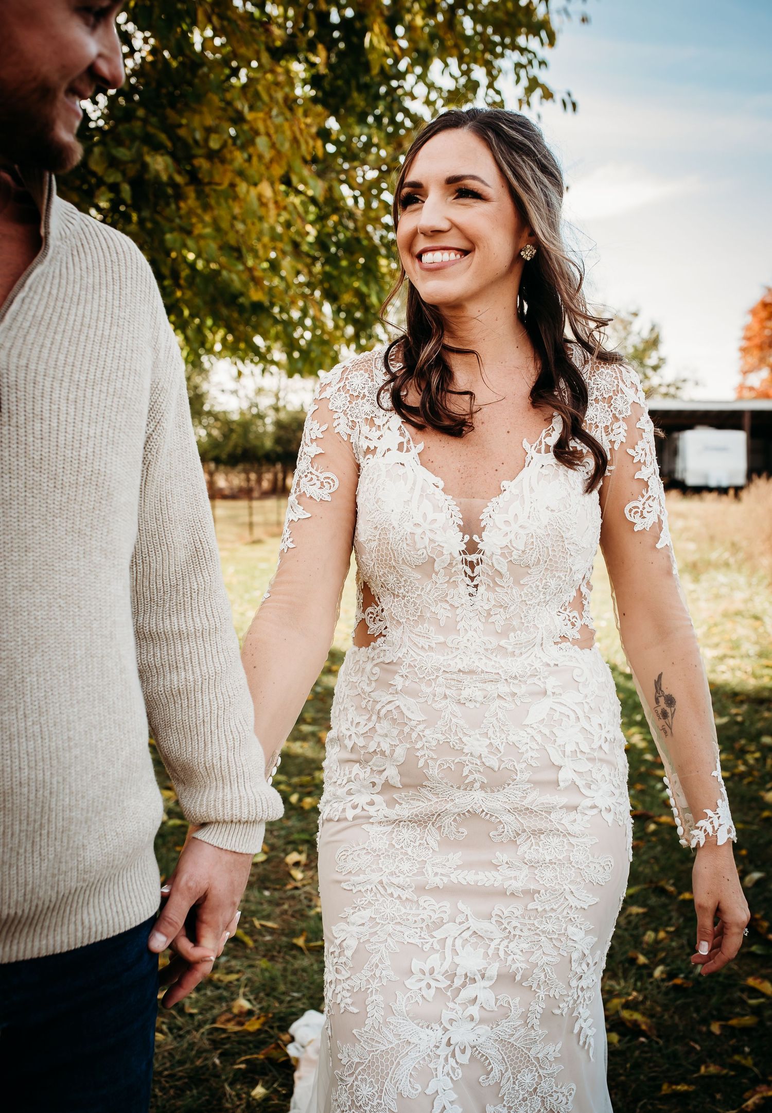 A stunning lace wedding dress detail shown in segments against a fall backdrop with golden leaves.