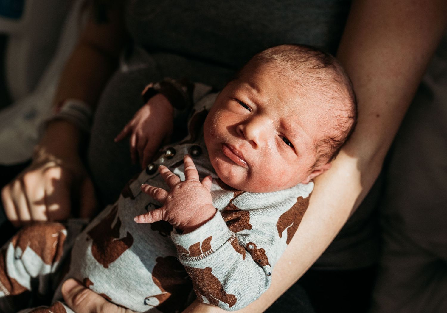 Gentle newborn care moments captured in warm natural lighting.