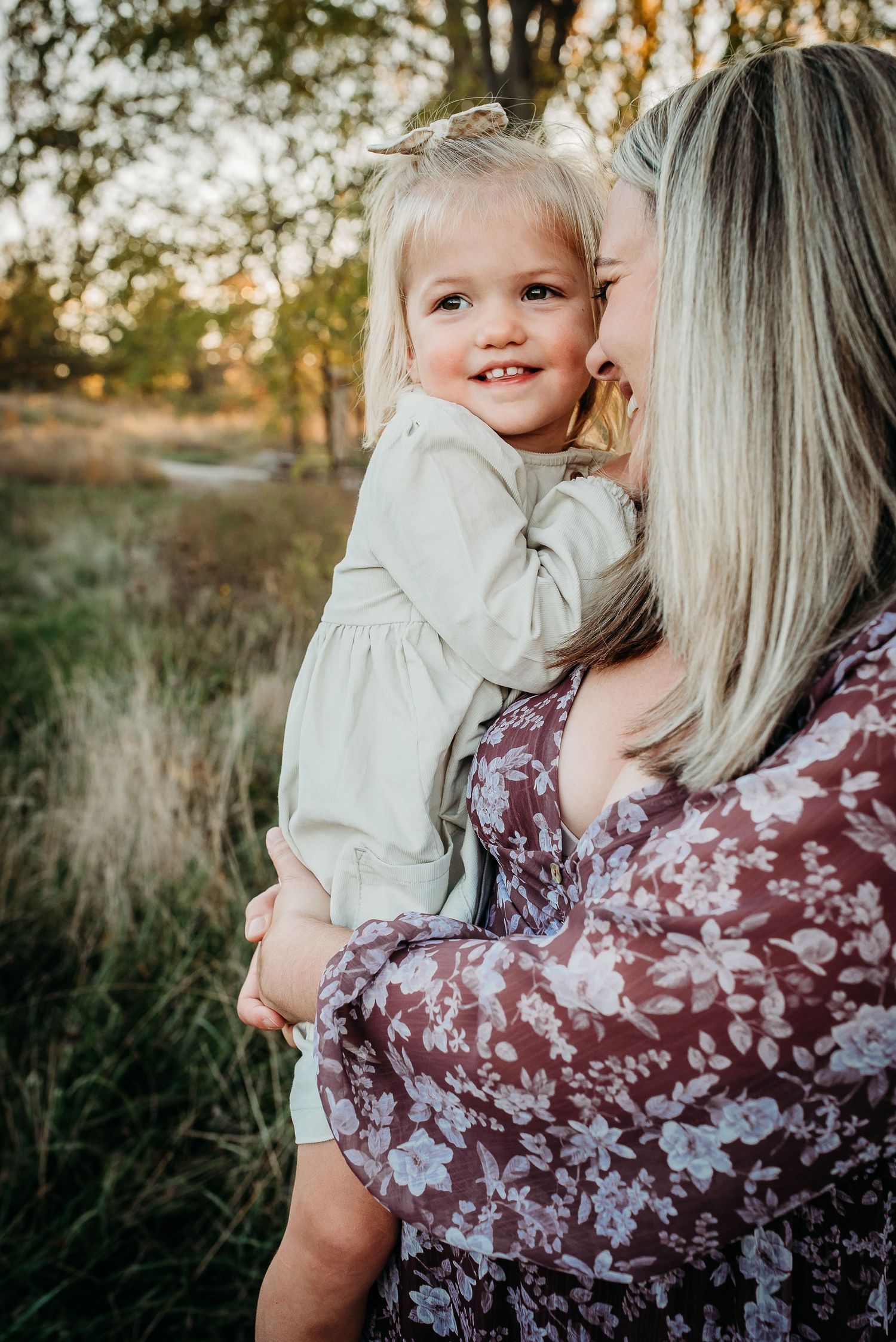 A sweet moment captured between two people during golden hour in a field.