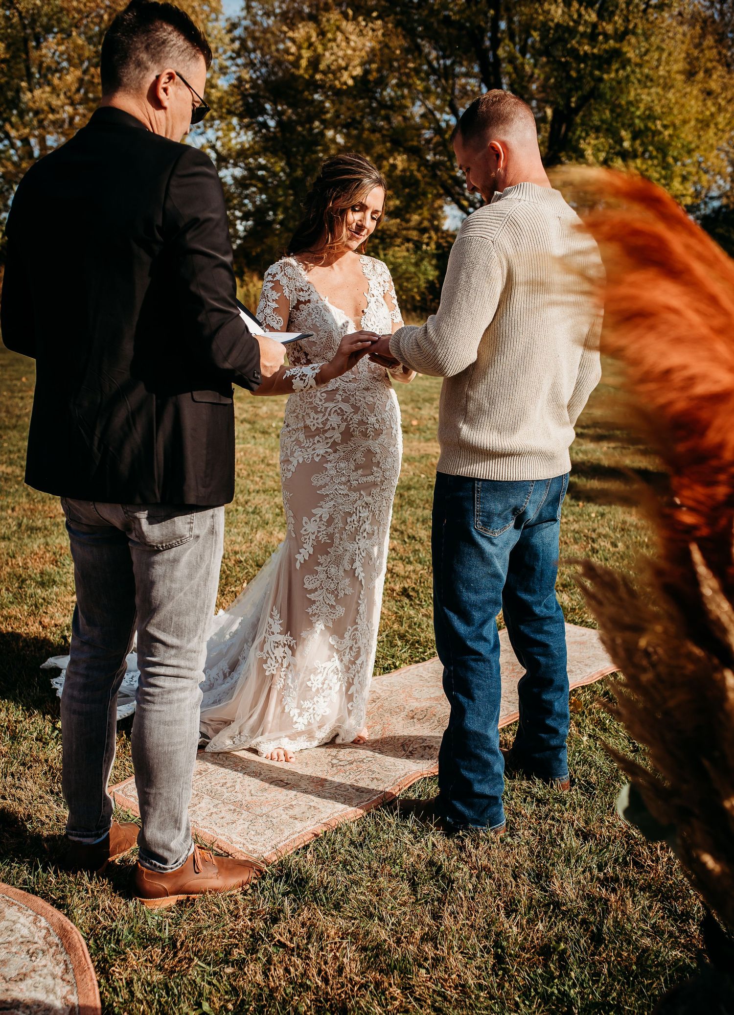 Outdoor wedding ceremony moments captured in warm autumn light.