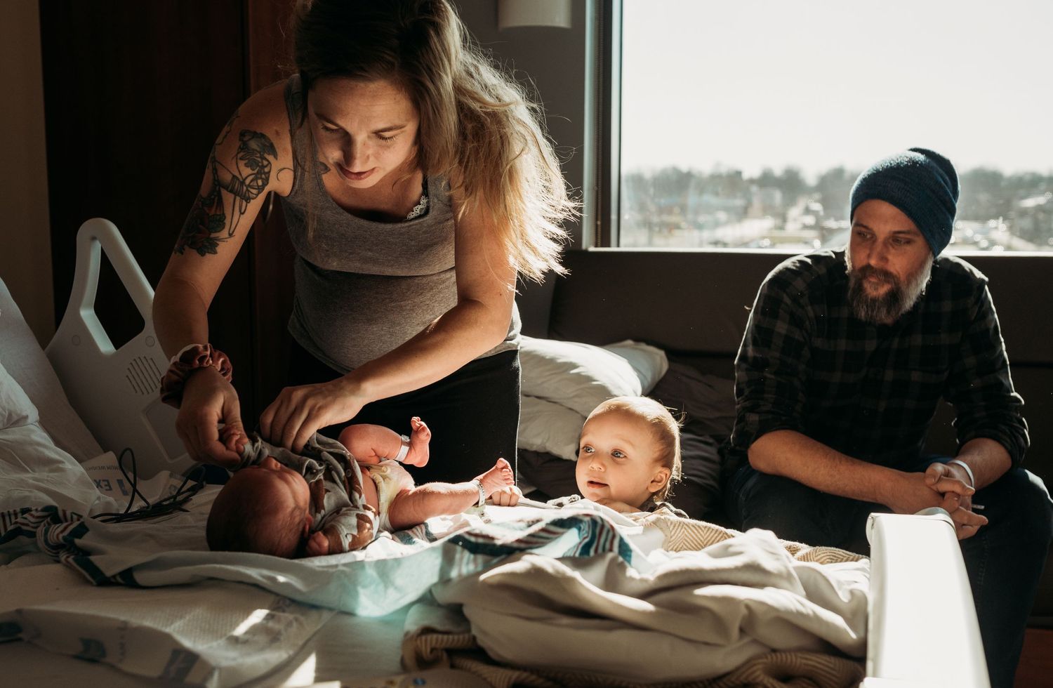 Light streams through windows during an indoor newborn photography session.