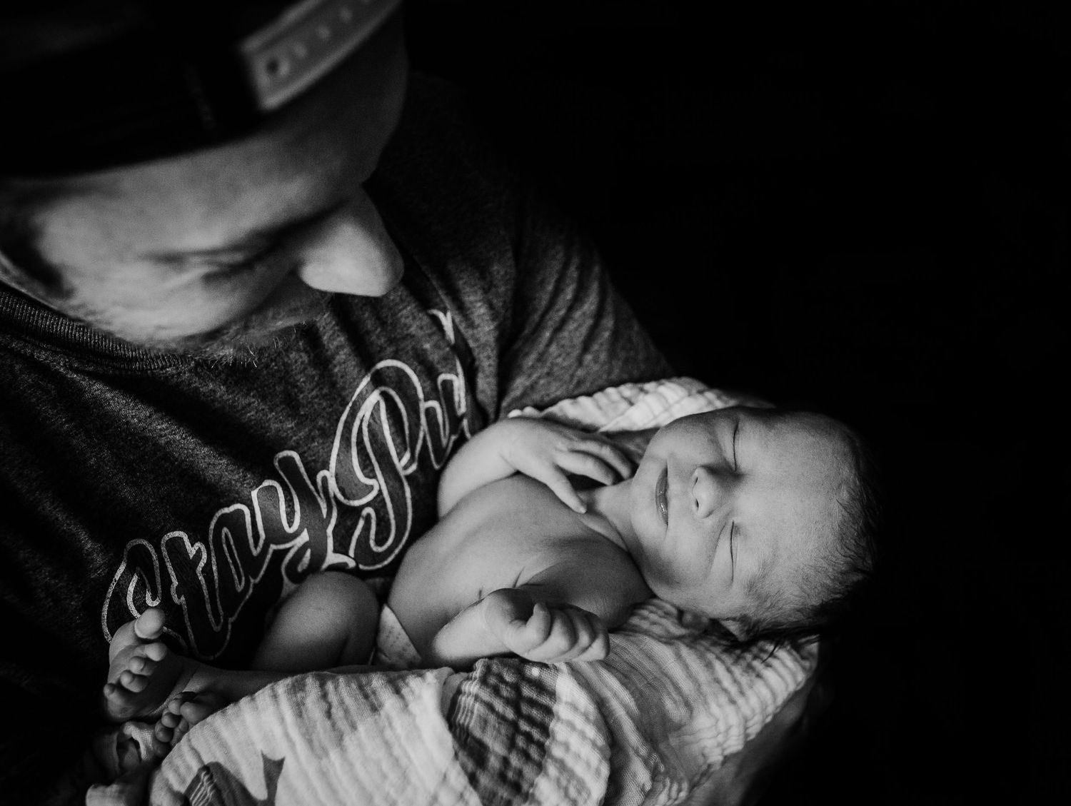 Black and white intimate close-up shots showing tender newborn moments.