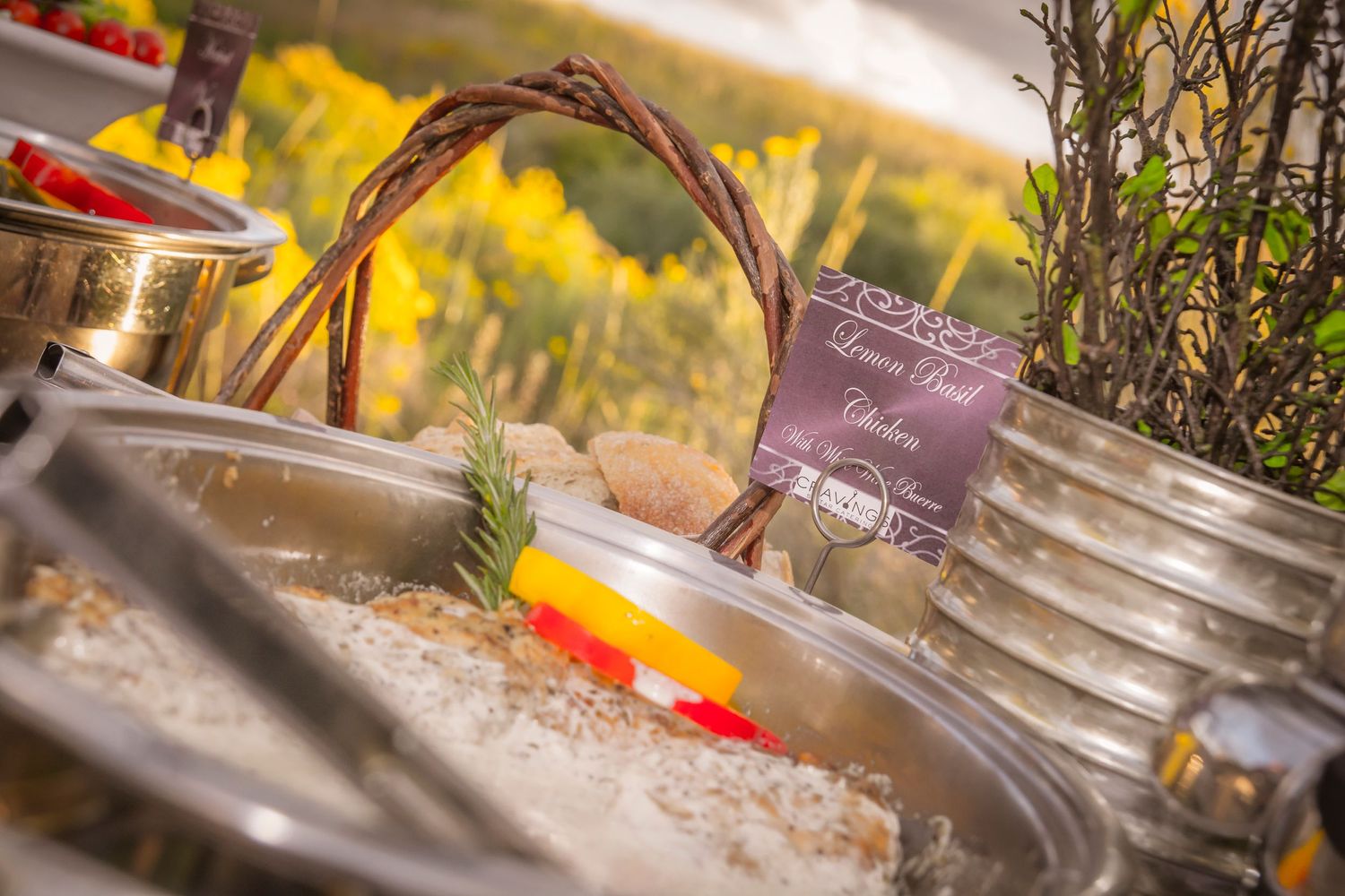 Wedding reception buffet table with decorative basket and serving dishes.