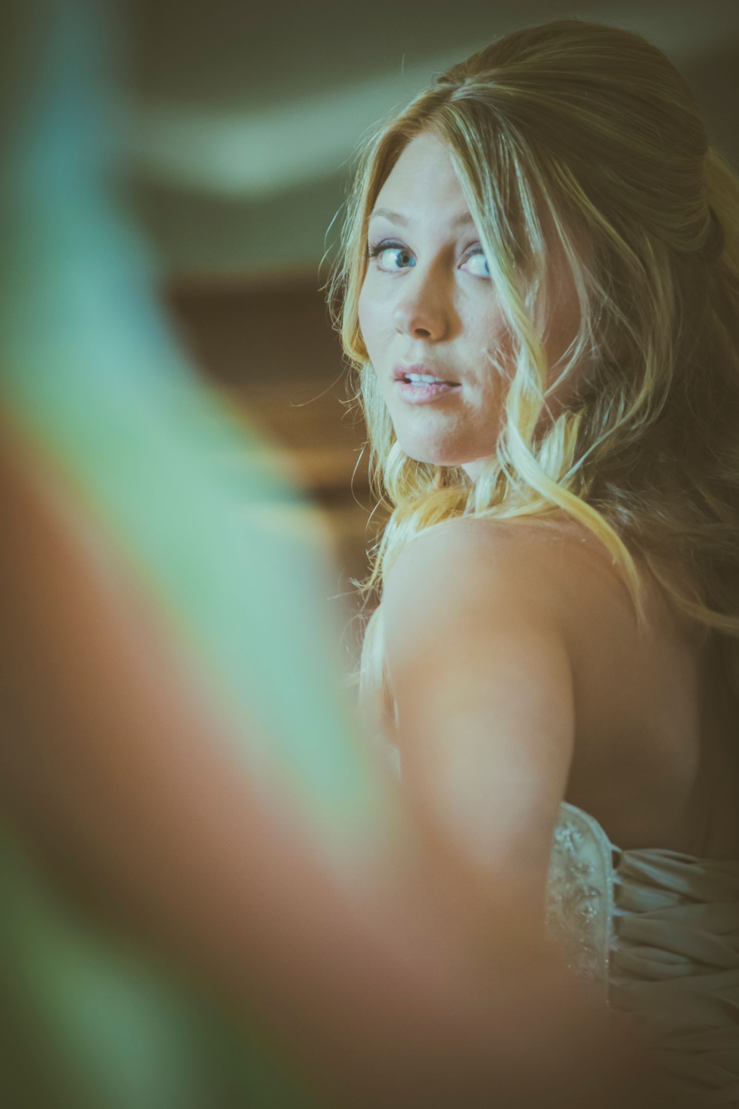Soft focus portrait of bride with blonde hair in romantic lighting.