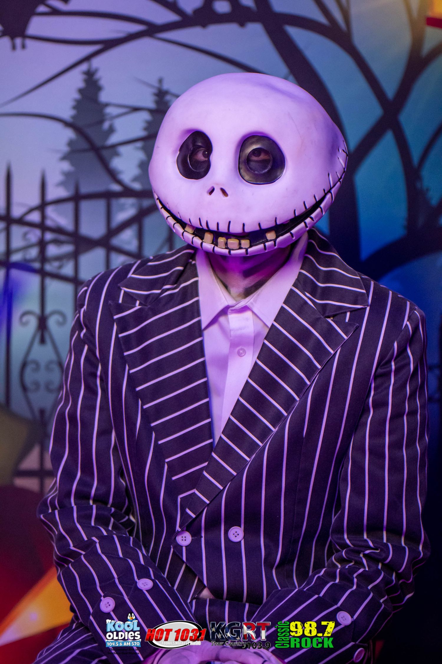 Jack Skellington cosplay character in pinstripe suit against spooky blue background.