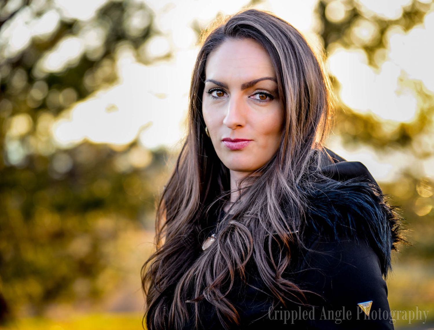 Natural light portrait with soft golden sunlight in the background.