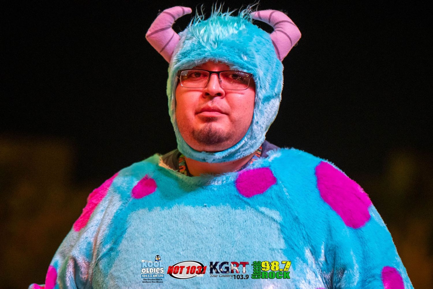 Participant wearing a blue and pink costume at an outdoor winter event.