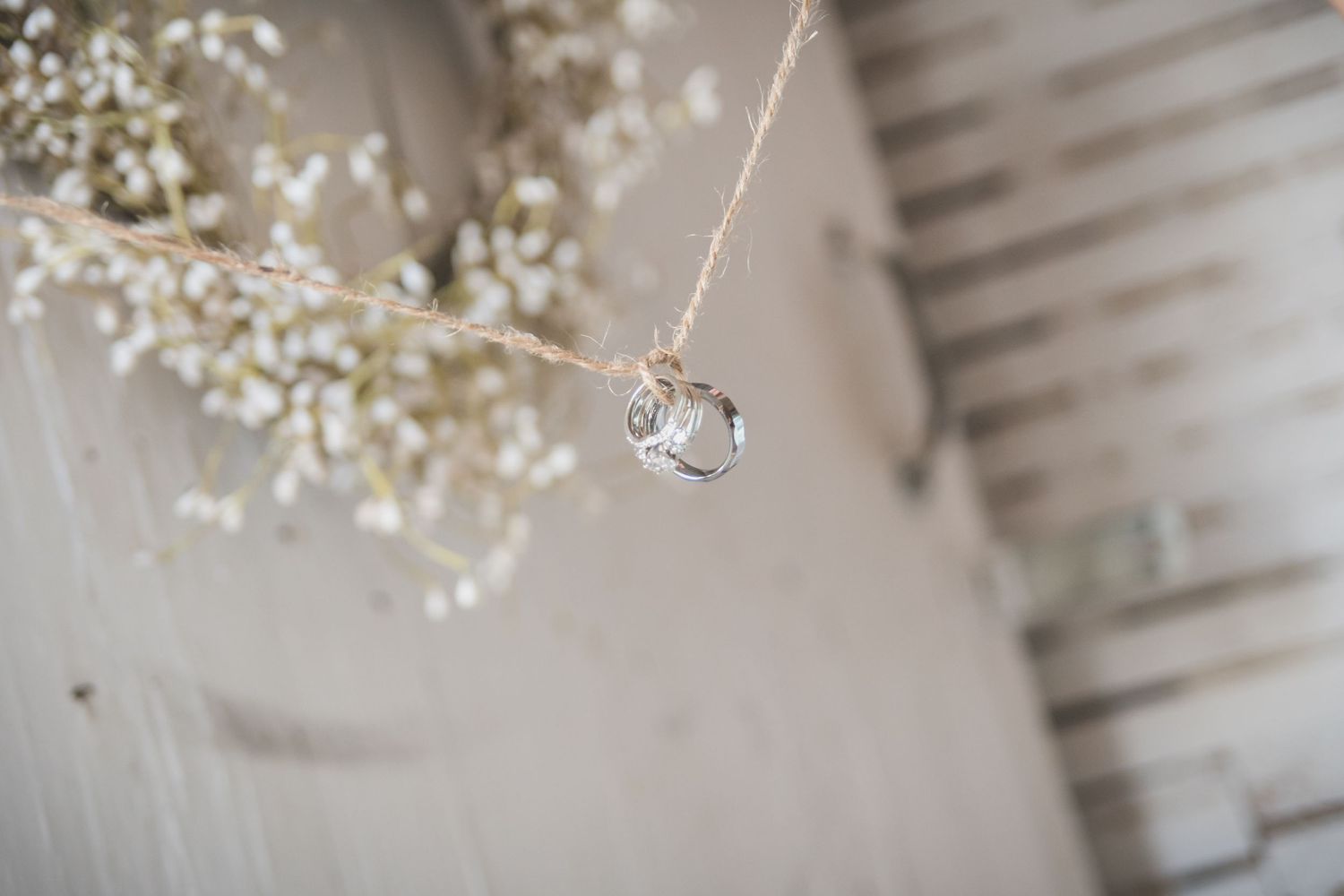 Crystal wedding decoration hanging from delicate white floral branch.