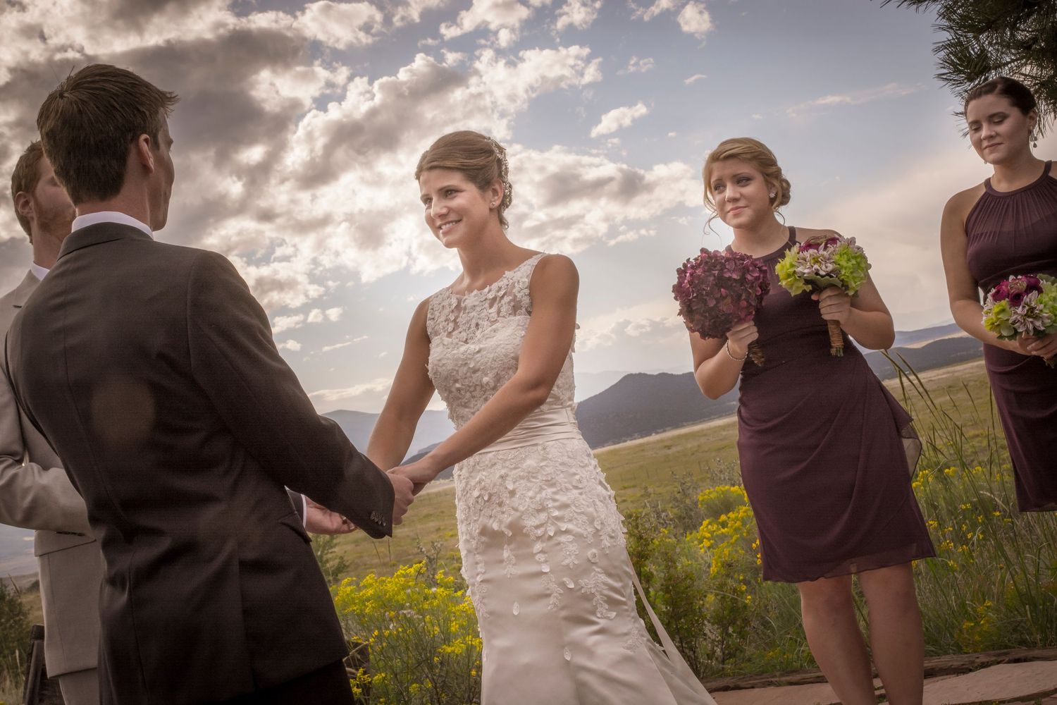 Wedding ceremony exchange of vows with scenic mountain view at sunset.