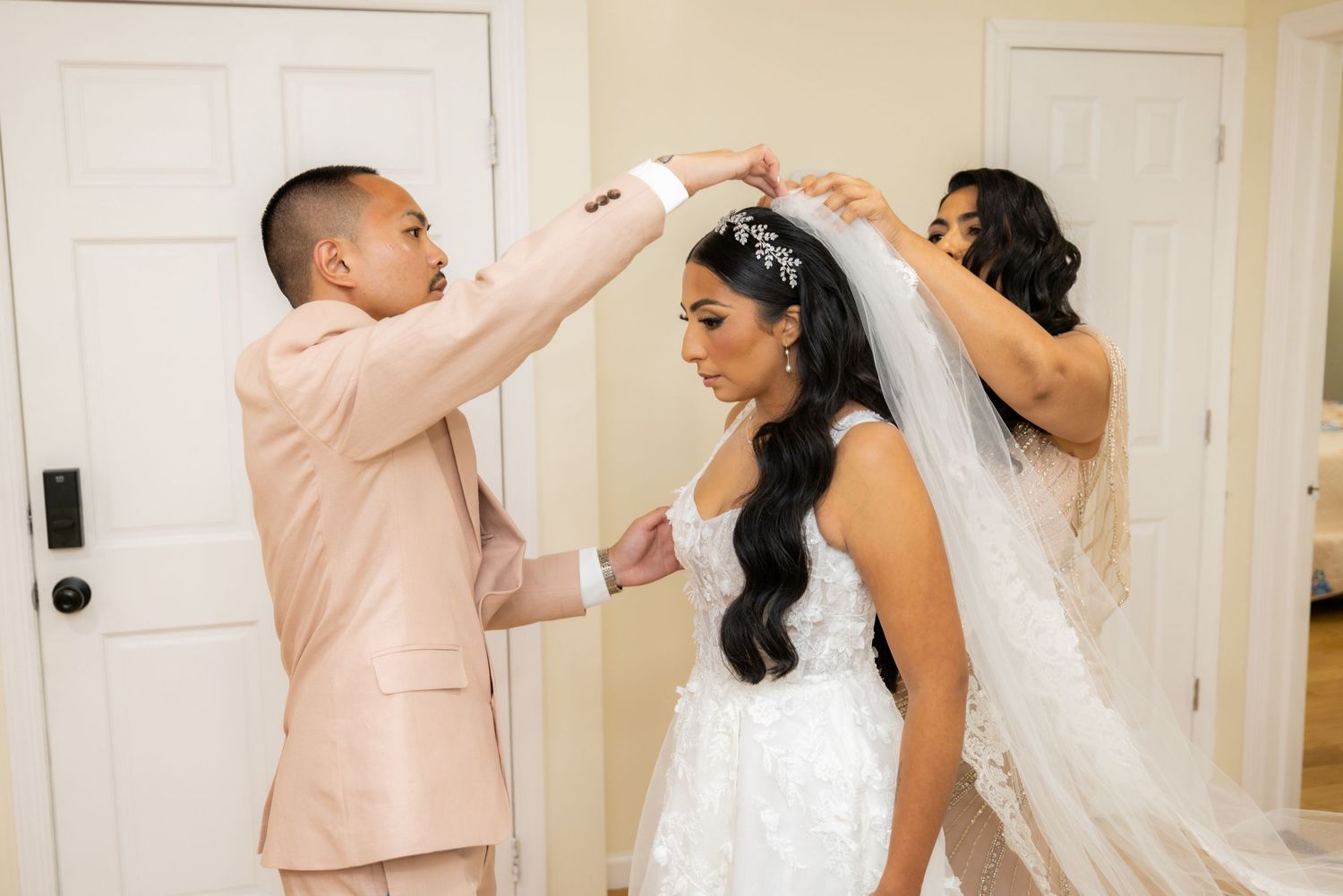 A couple dances together in formal attire at what appears to be a wedding celebration.