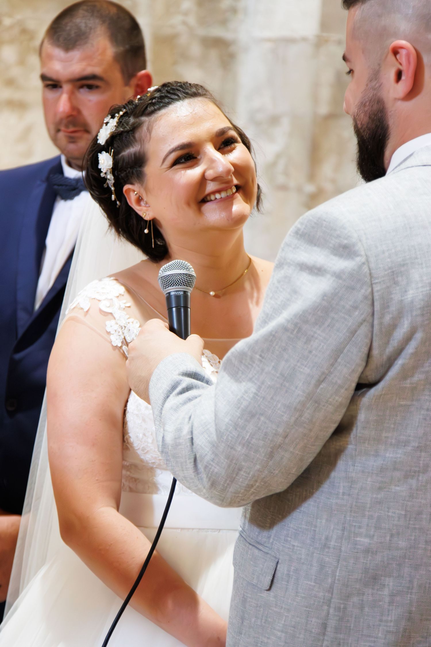 Candid wedding ceremony moments between couple in grey and white attire.