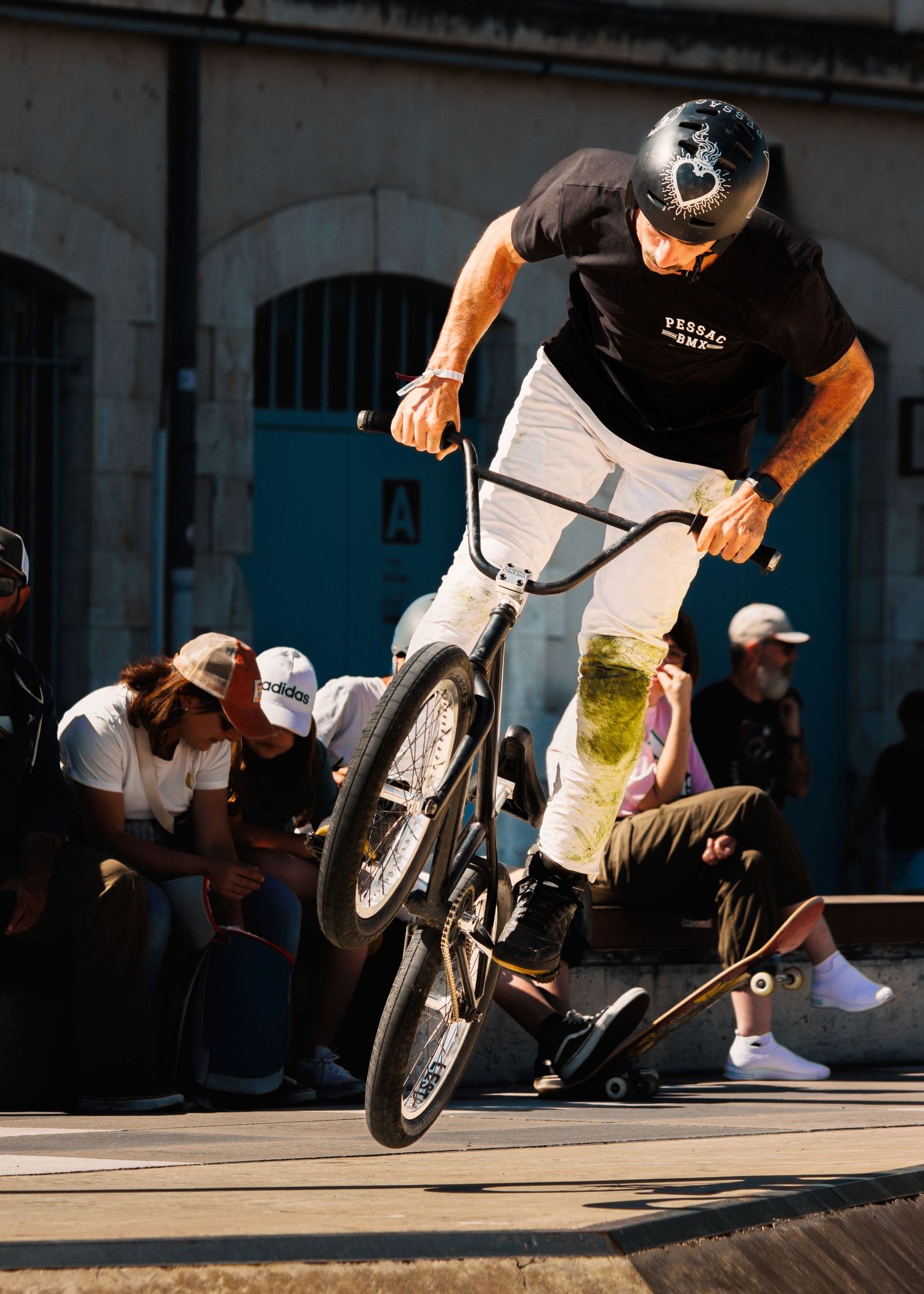 Sequence of BMX bike maneuvers showing airborne stunts over concrete ledge.