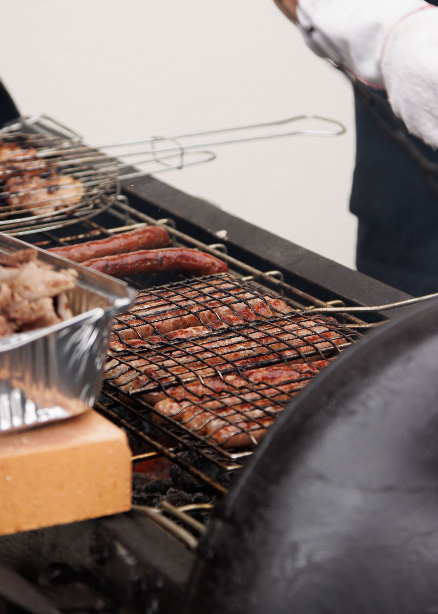 Close-up of meat grilling on a barbecue grill with metal grates.
