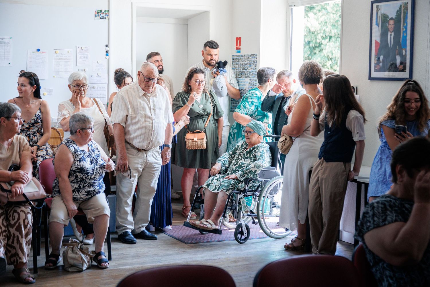 Wedding guests gathered inside a bright room celebrating a French civil marriage ceremony.
