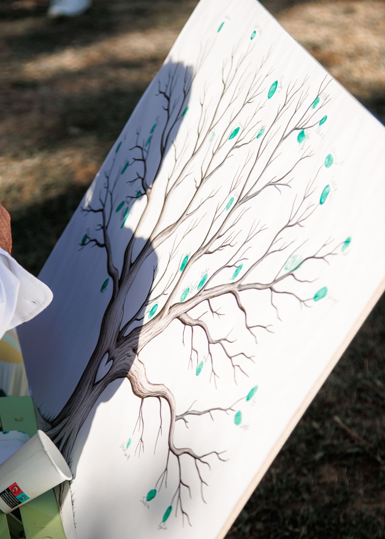 A sequence of white papers showing a hand-drawn bare tree branch with turquoise leaves gradually being added.