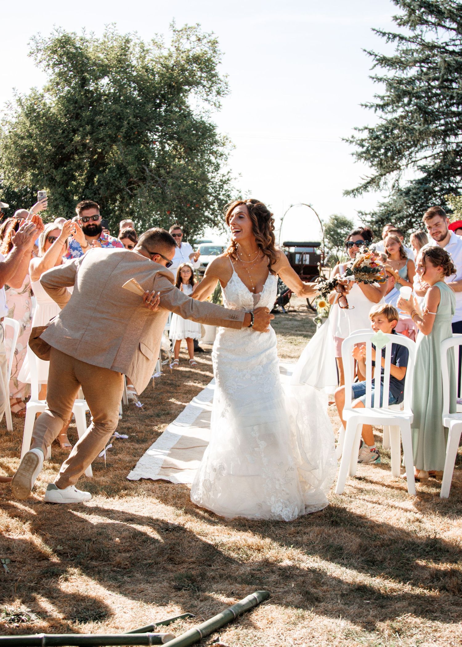 A collage of candid wedding party photos taken outdoors in natural sunlight showing joyful dancing and celebration.
