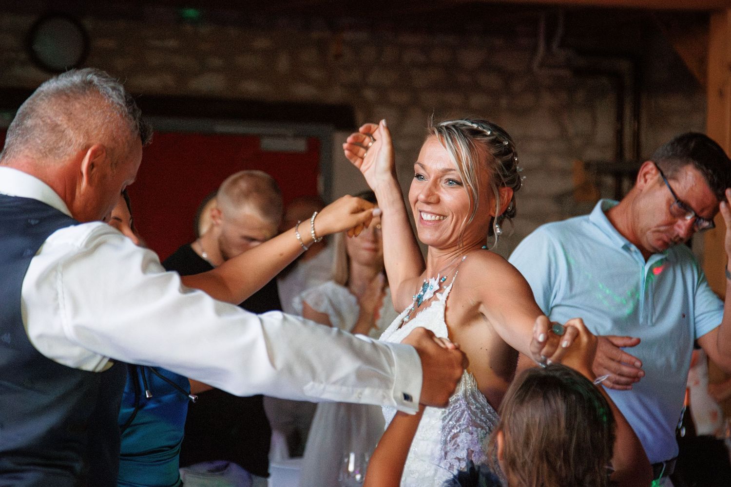 Joyful dancing and celebration at a wedding reception on the dance floor.