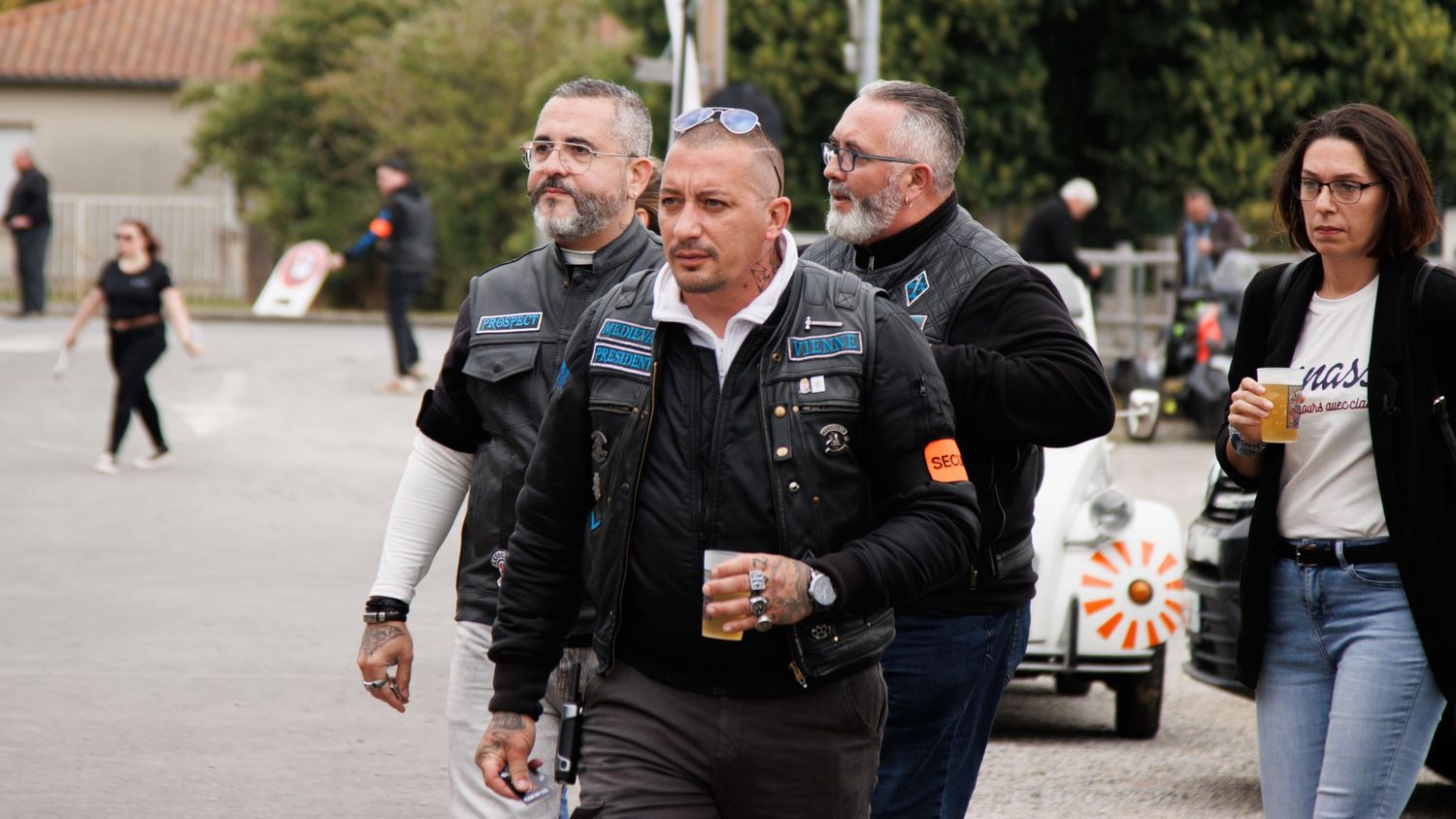Outdoor scene of people gathering at what appears to be a motorcycle event.