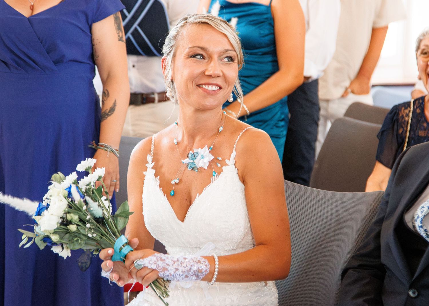 A wedding celebration scene with elegant floral decorations and formal attire.