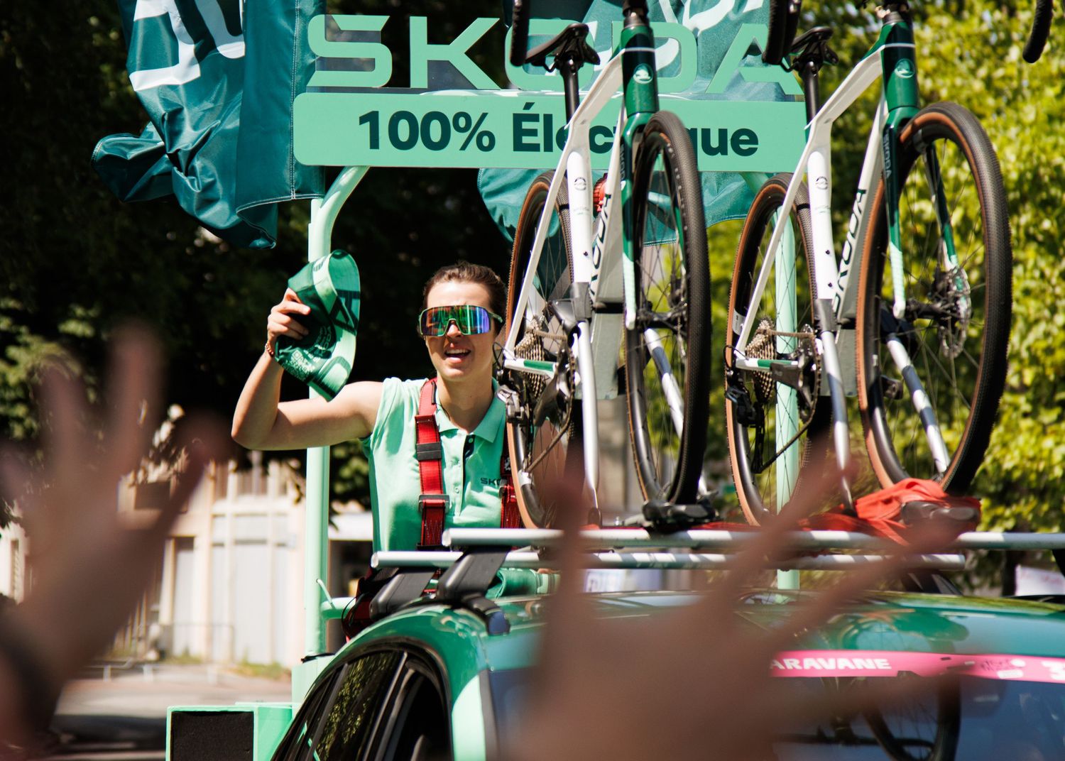 A cycling team vehicle carries spare bikes during a professional race event.