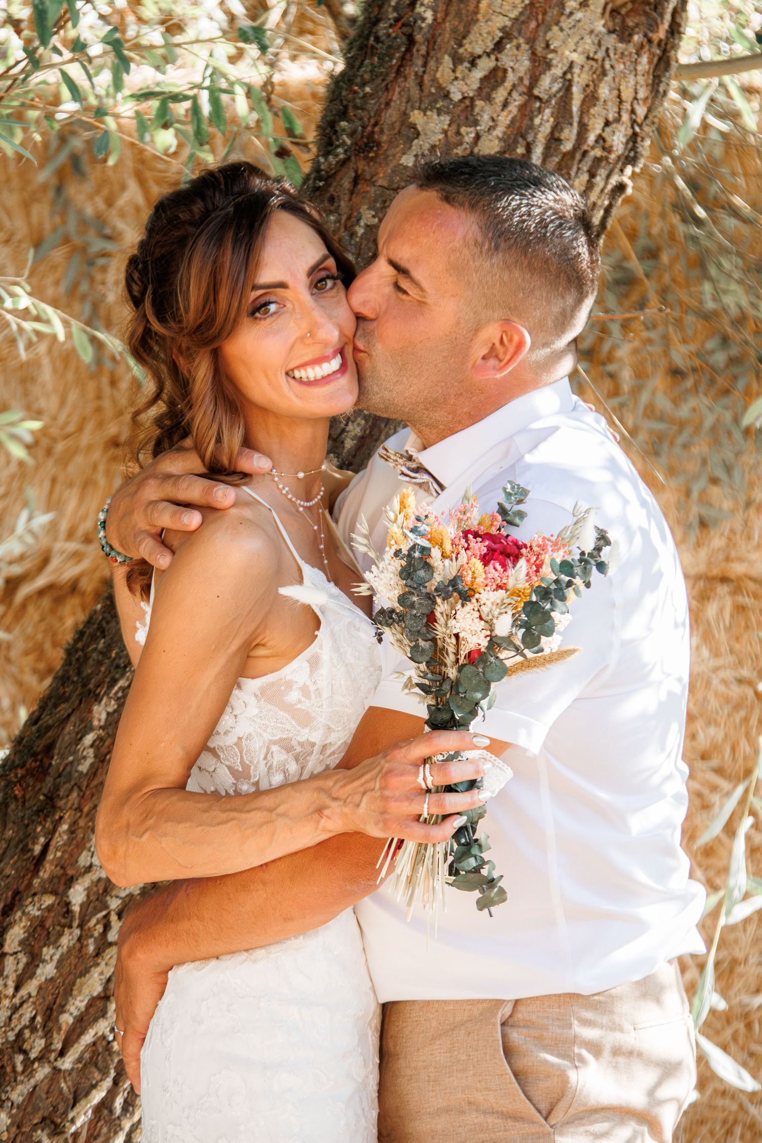 A romantic sequence of wedding photos showing tender moments between newlyweds under a tree canopy with sunlight filtering through.
