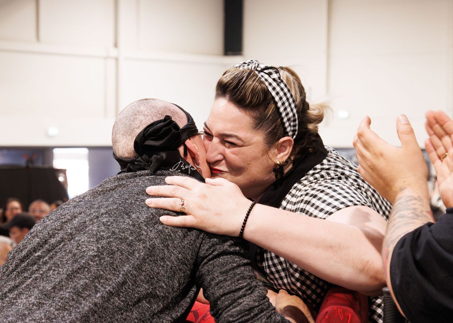 Emotional celebration moment during indoor competitive event.