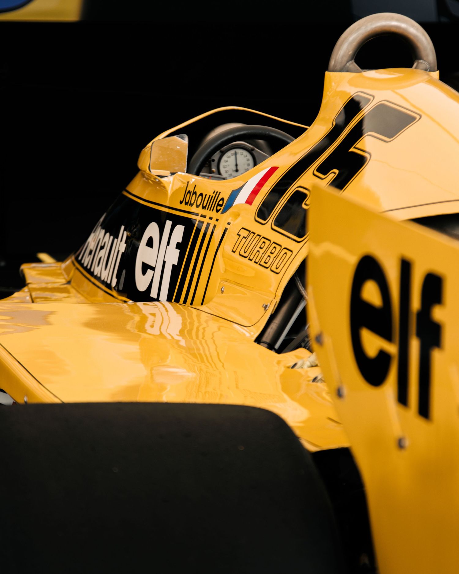 Yellow Renault Formula 1 car detail showing ELF sponsorship and aerodynamic bodywork.
