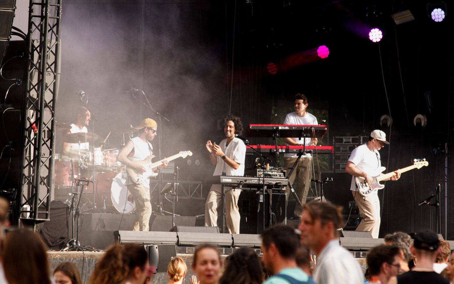 A collage of concert performance photos showing musicians on stage with lighting and crowd silhouettes visible.