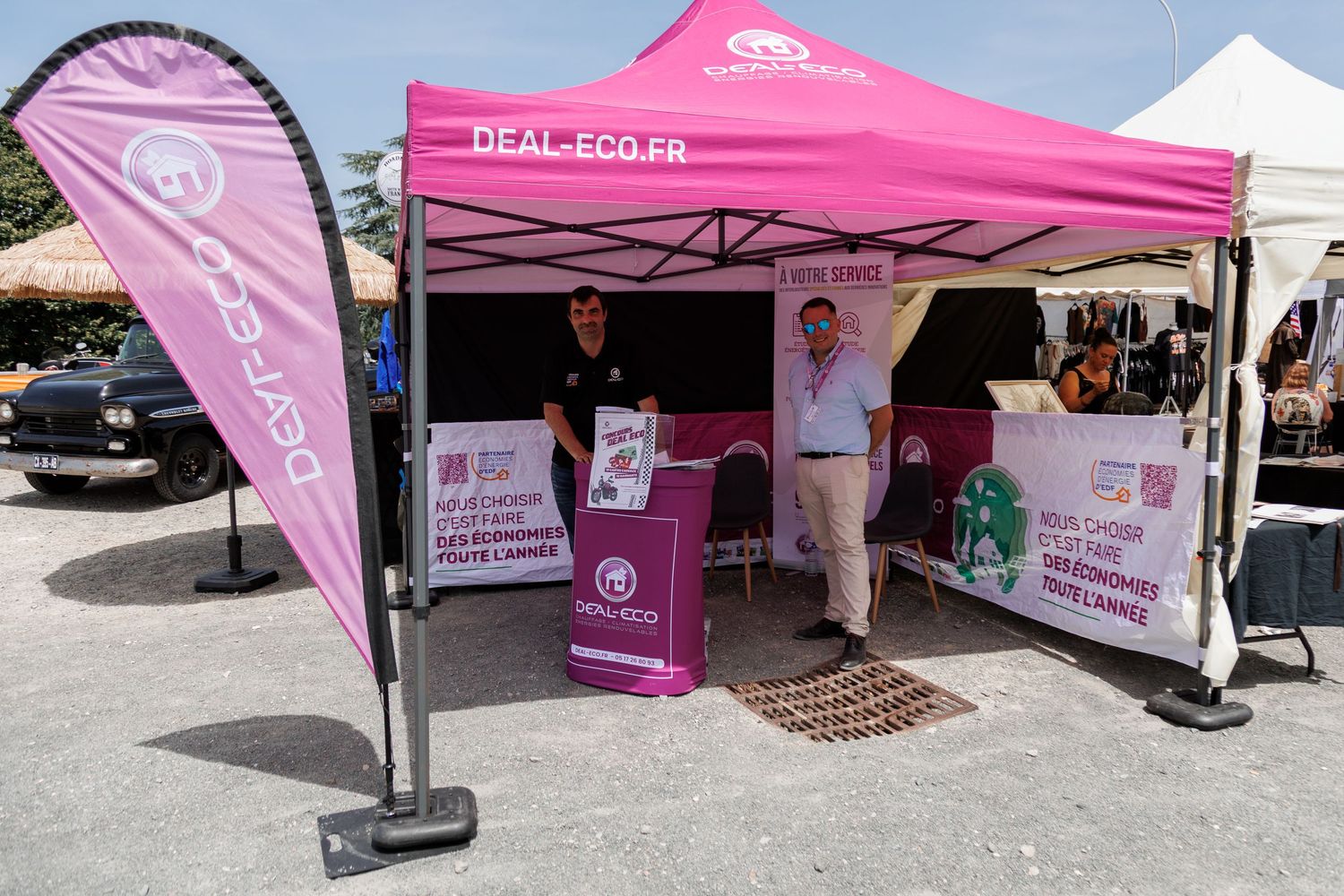 Pink Deal-Eco.fr promotional tent booth with two representatives at an outdoor event or market.