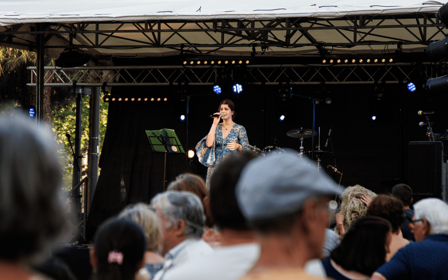 Professional audio setup with mixing boards and sound equipment at an outdoor venue.