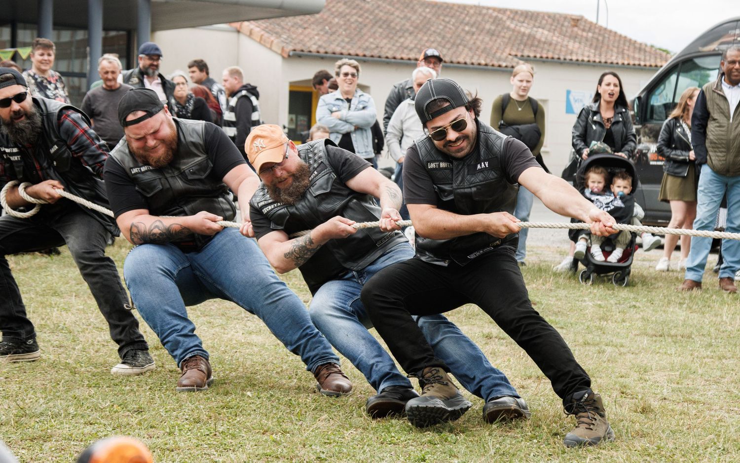 Group of people participating in a team building exercise on grass.