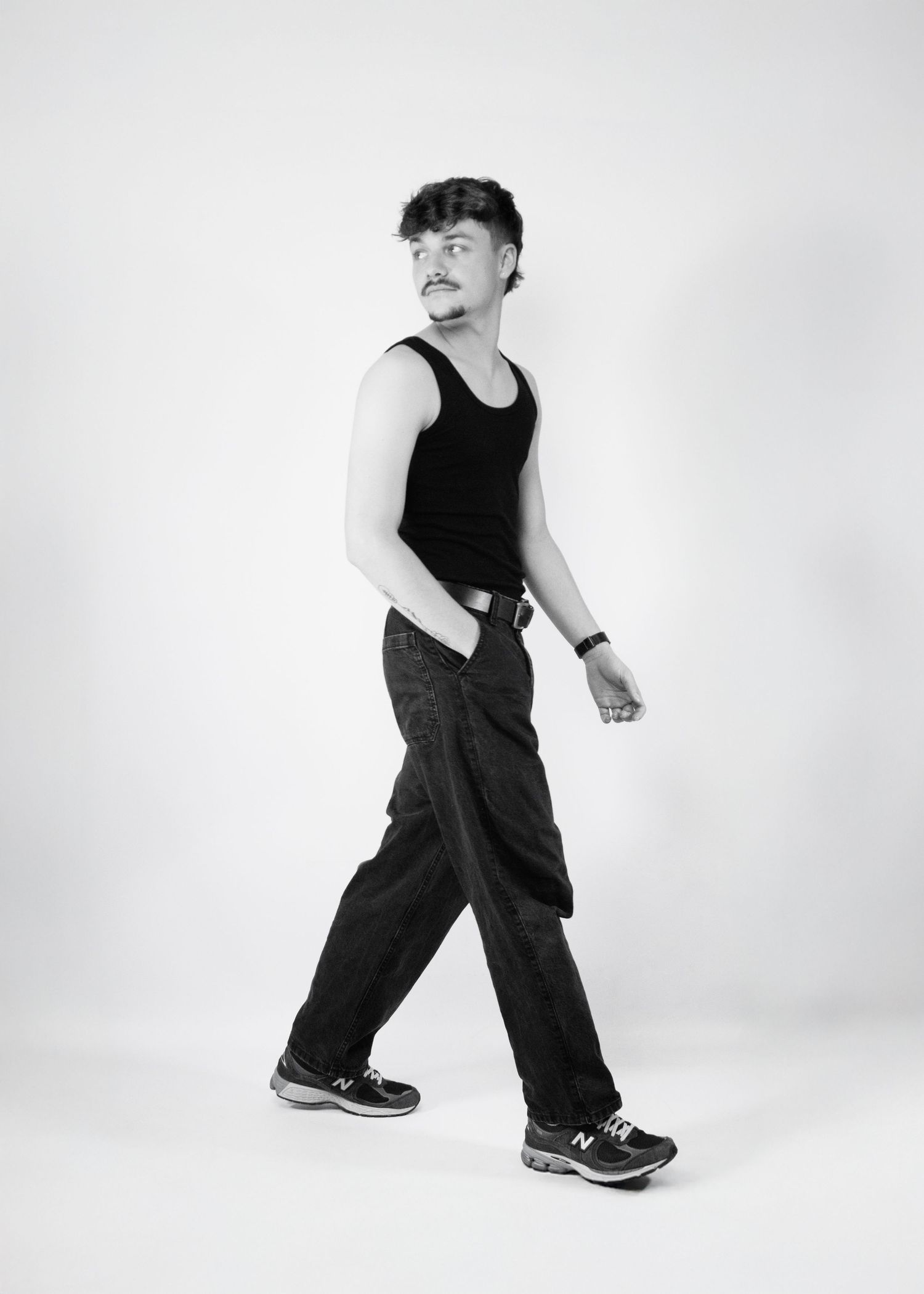 A sequence of black and white photos showing a person in dark clothing demonstrating dance steps against a white background.