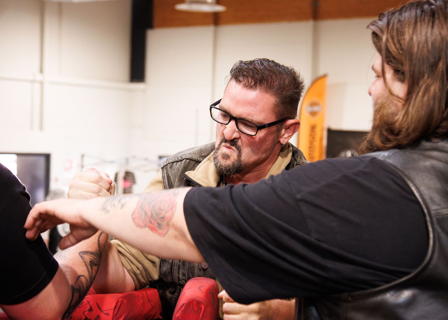 Participants engaged in arm wrestling competition.