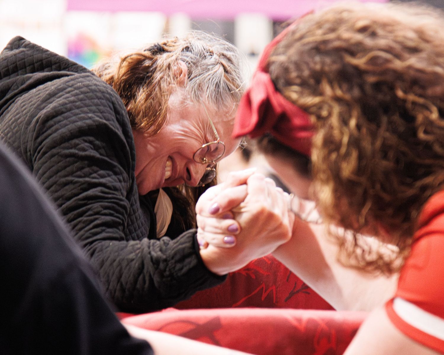 Close-up of people sharing an emotional moment at indoor event.