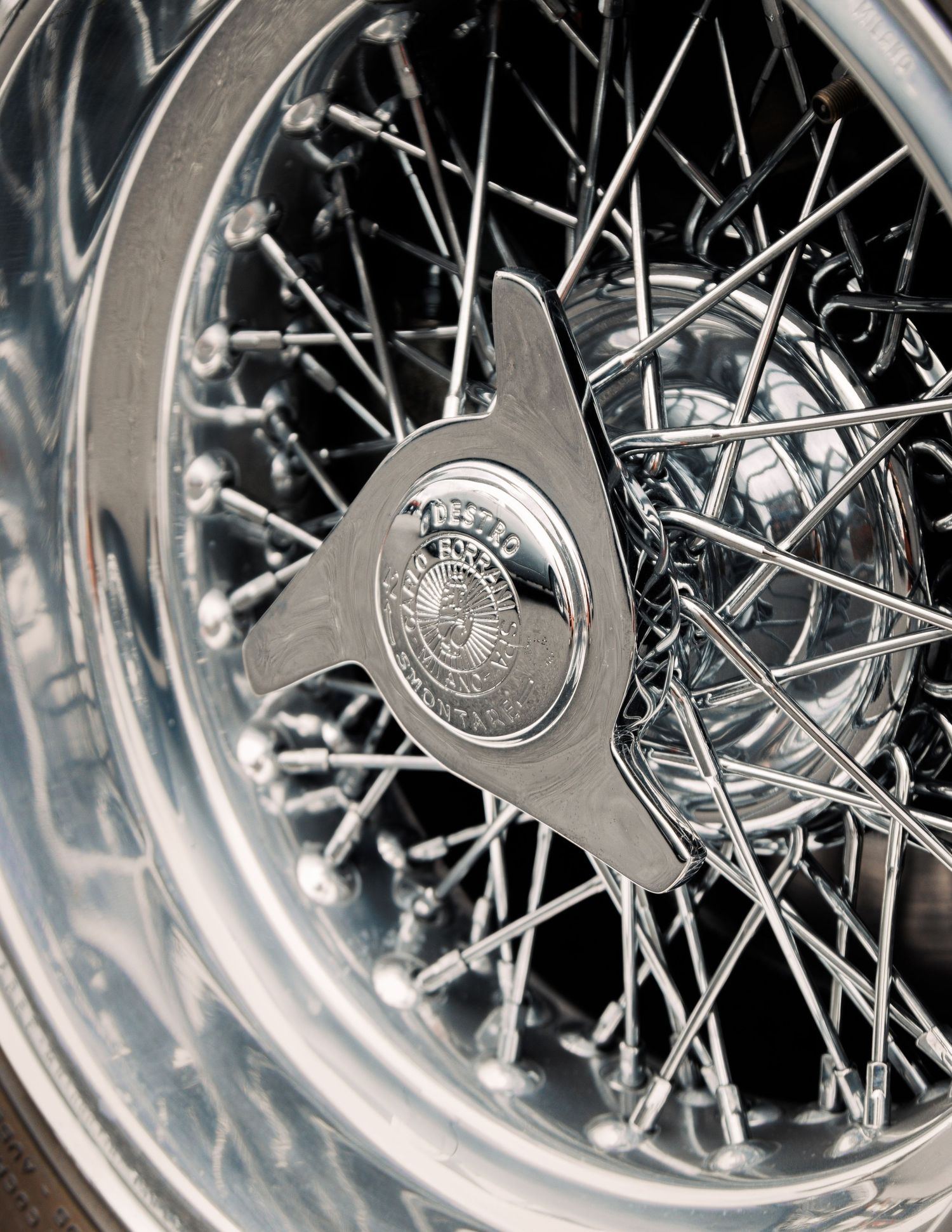 Detailed view of classic wire-spoke wheel with ornate silver hub caps.