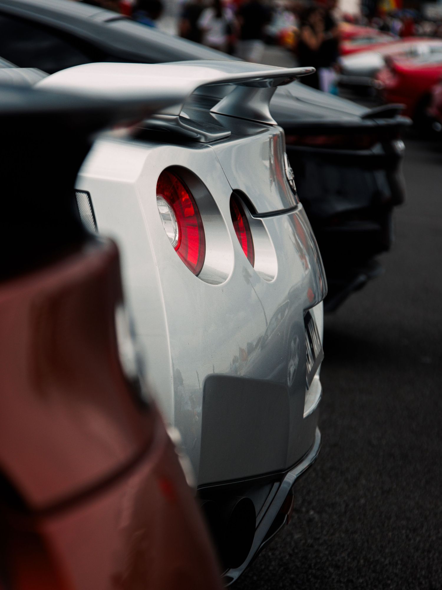 Abstract close-up of a silver automotive panel with curved design elements.